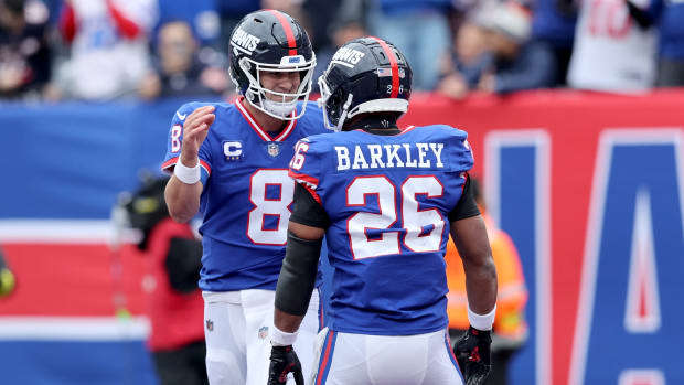 Oct 2, 2022; East Rutherford, New Jersey, USA; New York Giants quarterback Daniel Jones (8) celebrates his touchdown against the Chicago Bears with running back Saquon Barkley (26) during the first quarter at MetLife Stadium.